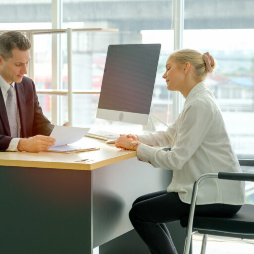 Beautiful blond hair girl talk with the business man for job interview.